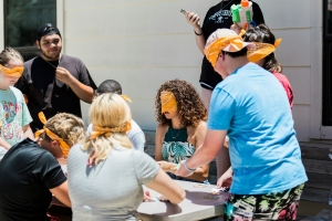 people standing and sitting on chair